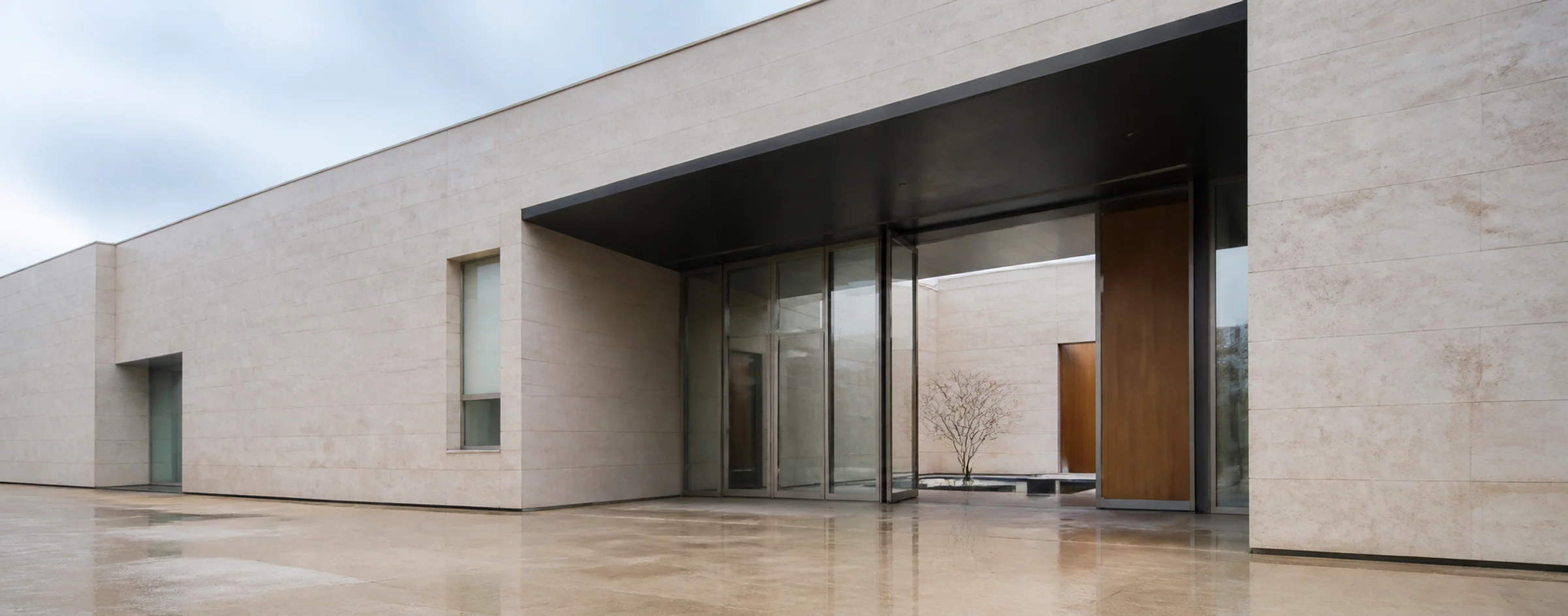 Cool neutral architectural entrance with stone, glass, and metal details